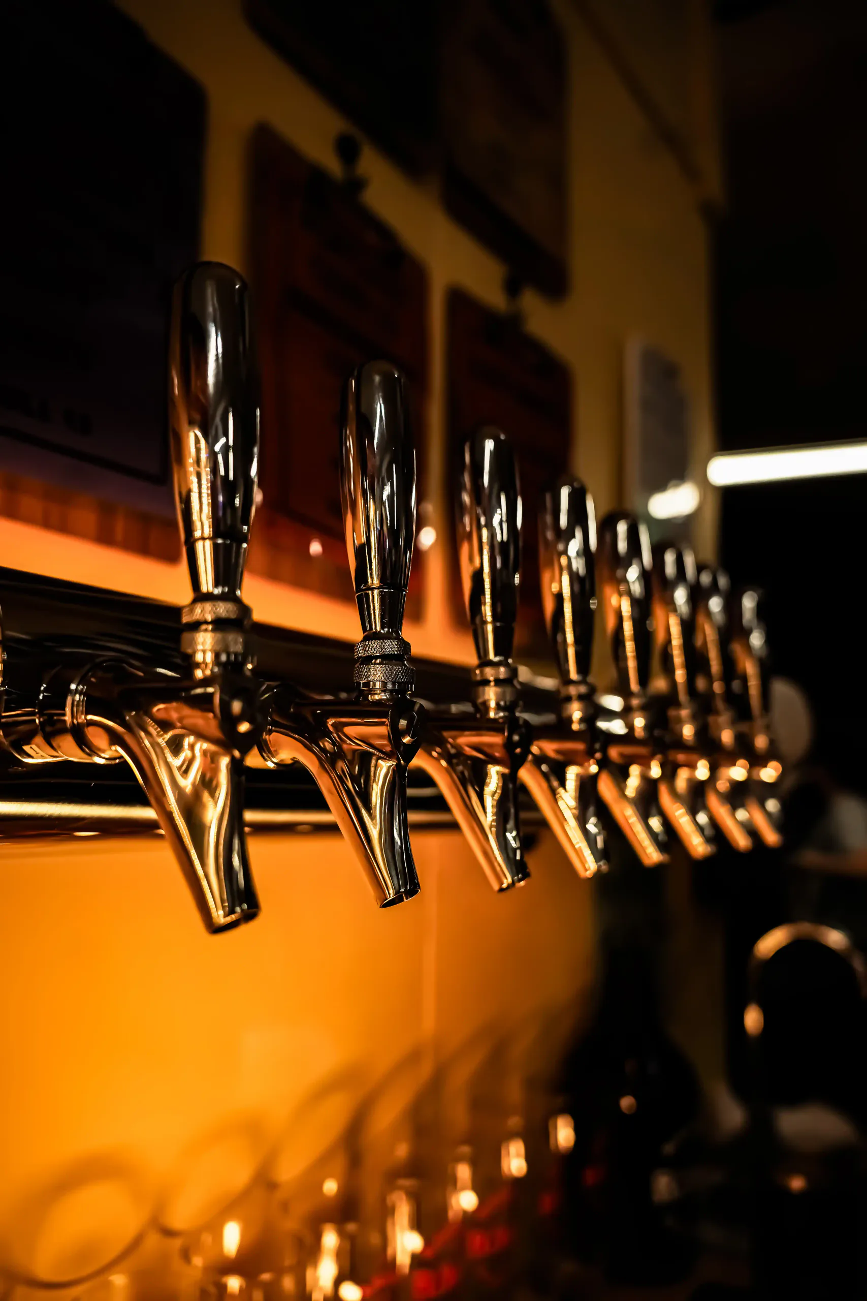 A row of beer taps behind the bar