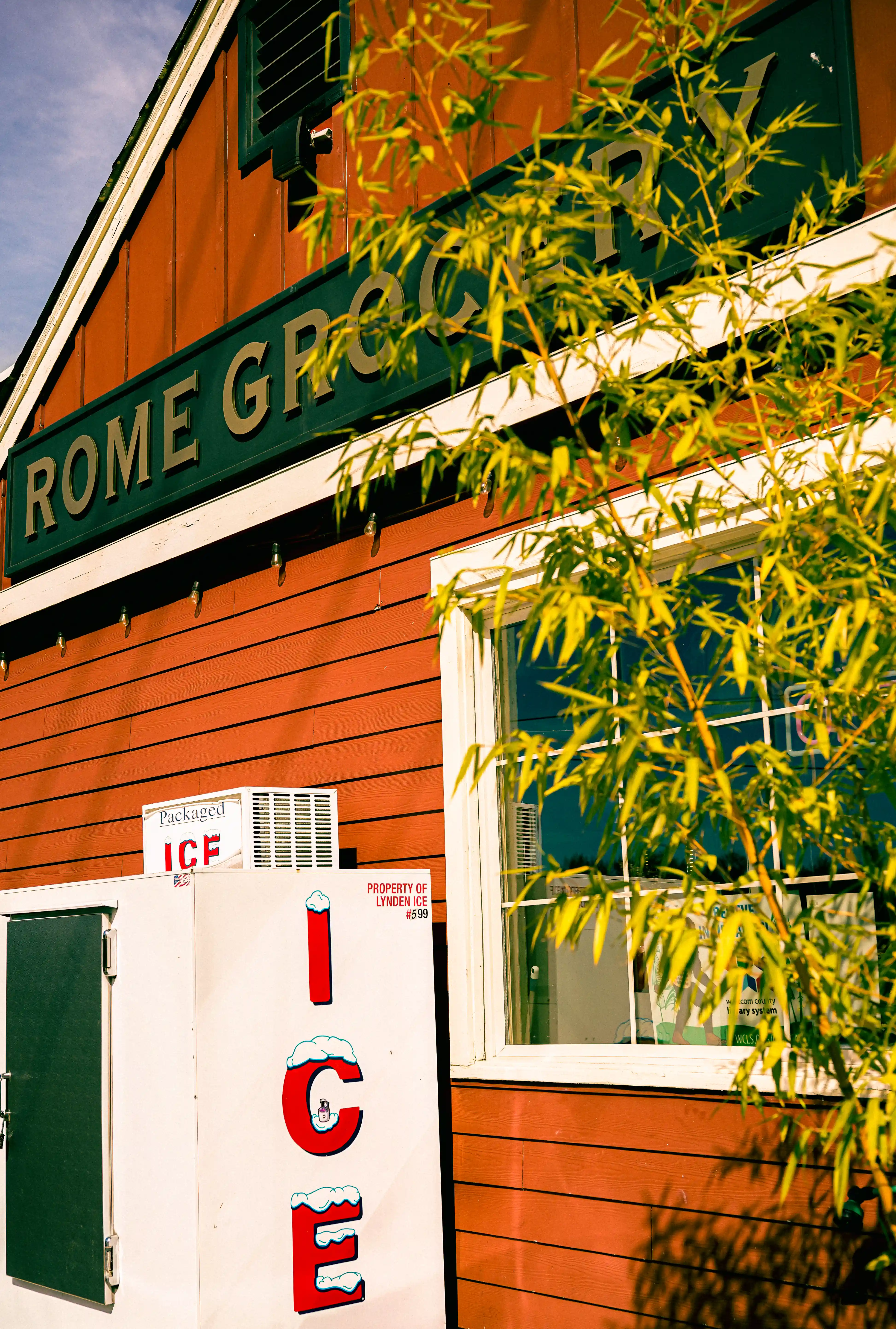 Exterior view of Rome, with a sign reading 'Ice' on the side of an ice cooler.
