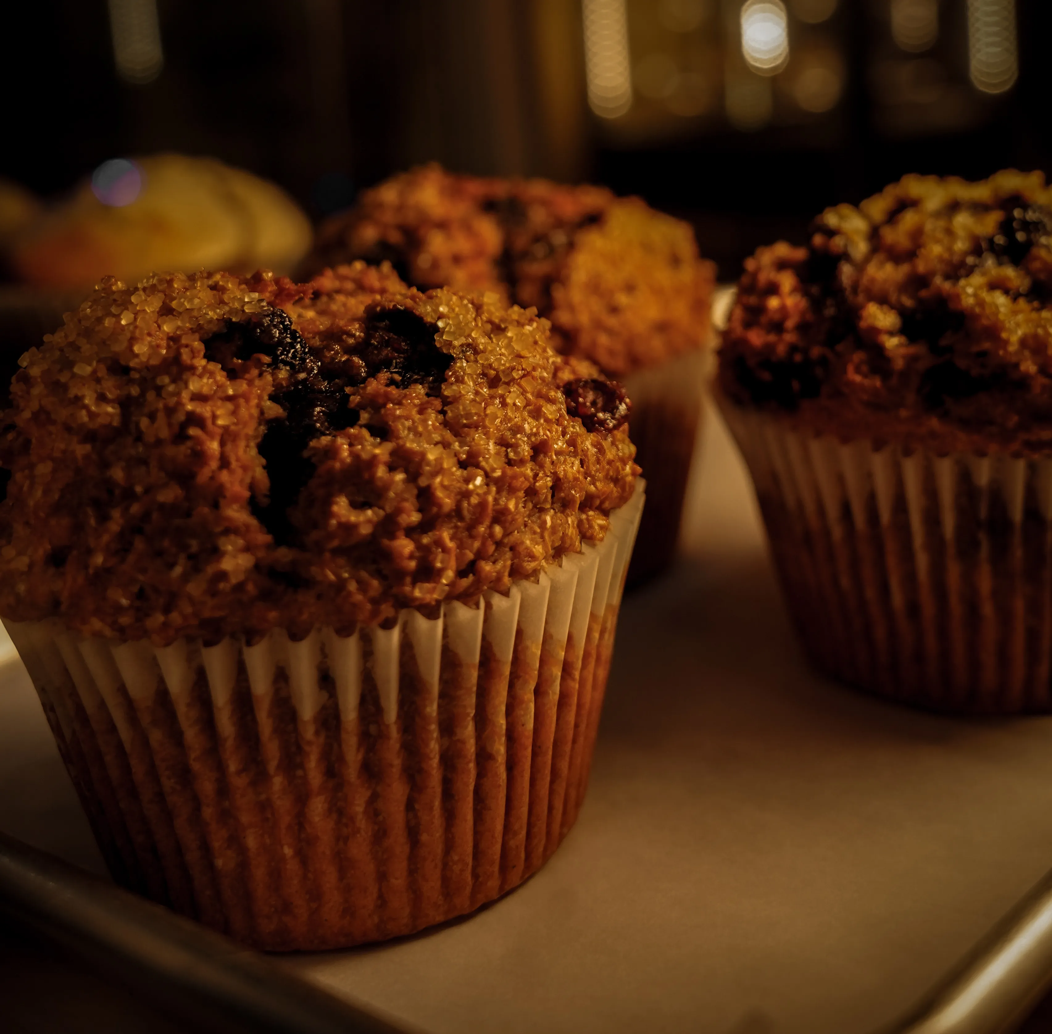 Freshly baked bran muffins with sugar crystals and fruit pieces