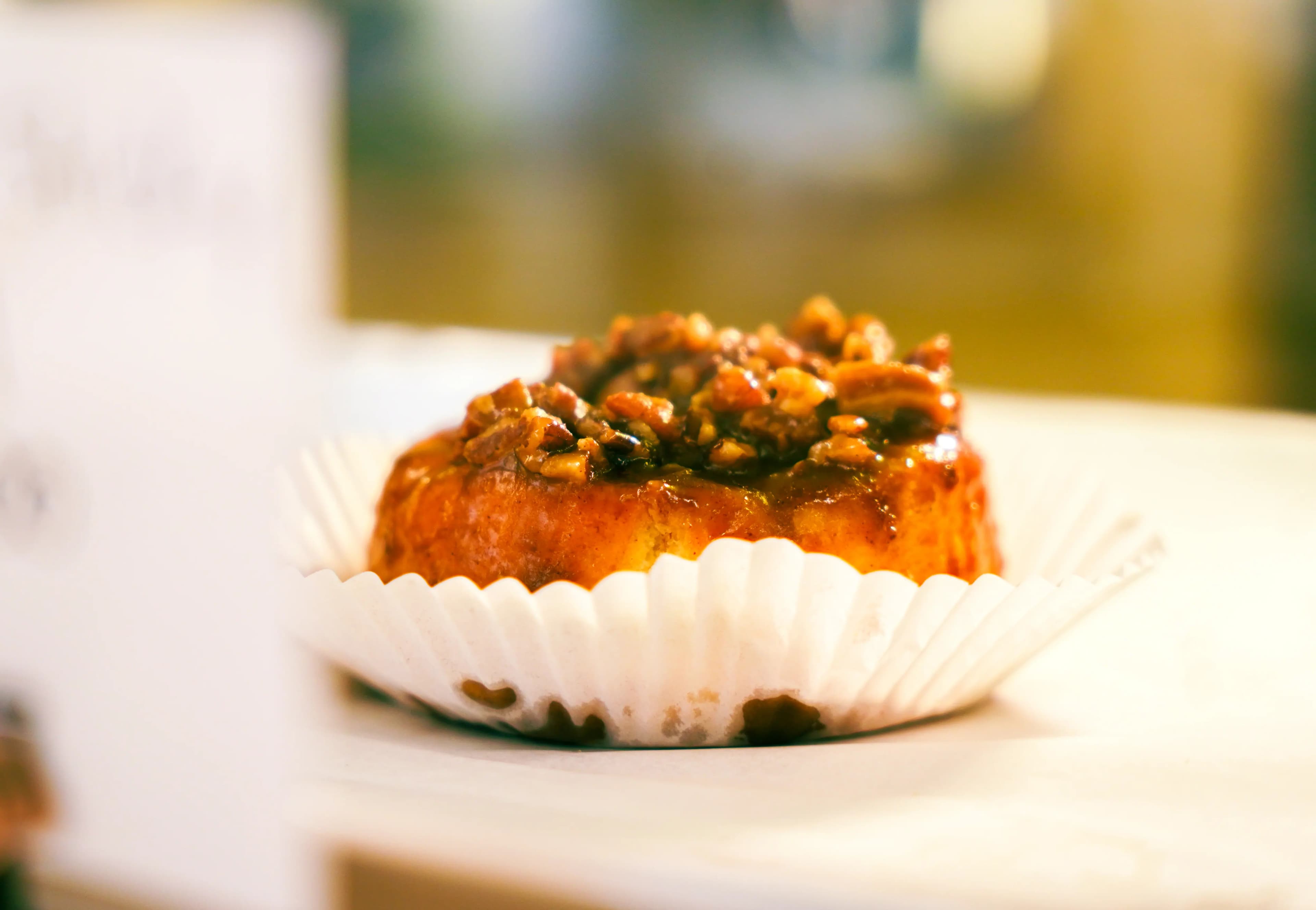 Fresh pecan roll displayed in the center of a pastry case